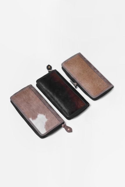 Genuine hair-on cowhide leather wallet with a natural black and white pattern and zipper closure.